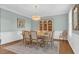 Elegant dining room with modern chandelier, wooden dining table, and wainscotting at 813 Bear Lake Dr., Longs, SC 29568