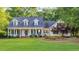 Charming two-story home featuring a columned front porch and beautifully landscaped front yard at 813 Bear Lake Dr., Longs, SC 29568