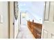Light and airy hallway with carpet flooring, white trim, and a wooden railing at 813 Bear Lake Dr., Longs, SC 29568