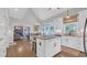 Kitchen with white cabinets, stainless appliances, granite countertops, and open view to living room at 813 Bear Lake Dr., Longs, SC 29568