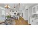 Bright kitchen features white cabinets, stainless steel appliances, and a breakfast nook with a chandelier at 813 Bear Lake Dr., Longs, SC 29568
