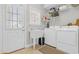 Well-organized laundry room featuring washer, dryer, sink, and ample storage space at 813 Bear Lake Dr., Longs, SC 29568