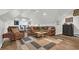 Cozy living room with a brown leather couch, a unique coffee table, and a bar at 813 Bear Lake Dr., Longs, SC 29568