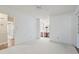 Spacious bedroom with carpet, a ceiling fan, and a doorway view of the ensuite bathroom at 88 Purple Martin Dr., Murrells Inlet, SC 29576