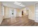 Bright living room featuring hardwood floors, a skylight, and open access to other rooms at 88 Purple Martin Dr., Murrells Inlet, SC 29576