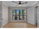 Cozy bedroom offers wood floors, large window, and a ceiling fan at 900 Courtyard Dr. # K7, Myrtle Beach, SC 29577