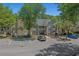 A well-maintained condo building with two stories, mature trees, and convenient parking spaces at 900 Courtyard Dr. # K7, Myrtle Beach, SC 29577