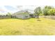 Spacious backyard with green grass, featuring a fire pit and a screened porch at 908 Hornbeam Ct., Loris, SC 29569