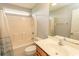 Bathroom featuring a shower-tub combo with white tile surround, toilet, and a vanity with ample countertop space at 908 Hornbeam Ct., Loris, SC 29569