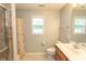 Bathroom showcasing a shower, window, and neutral walls at 908 Hornbeam Ct., Loris, SC 29569
