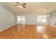 Spacious living room with hardwood floors, ceiling fan, and sliding glass doors to the back porch at 908 Hornbeam Ct., Loris, SC 29569