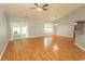 Hardwood floors and sliding glass doors define this living room space, complemented by a ceiling fan and modern lighting at 908 Hornbeam Ct., Loris, SC 29569