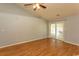 Living room with hardwood floors and sliding glass doors leading to a covered patio with a ceiling fan at 908 Hornbeam Ct., Loris, SC 29569