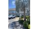 Charming townhomes with neutral siding, blue shutters, and mature landscaping, next to parking area and palm tree at 913 Villa Dr. # 913, North Myrtle Beach, SC 29582