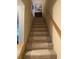 Carpeted staircase with a wooden handrail, leading to upper floors, offering comfort and safety at 913 Villa Dr. # 913, North Myrtle Beach, SC 29582