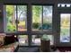 Relaxing sunroom with large windows showcasing a serene view of the lush backyard and garden at 913 Villa Dr. # 913, North Myrtle Beach, SC 29582