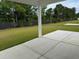 Covered patio with a view of a spacious fenced backyard and newly planted trees at 945 Laconic Dr., Myrtle Beach, SC 29588