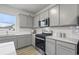Modern kitchen featuring stainless steel appliances, gray cabinets, and white subway tile backsplash at 945 Laconic Dr., Myrtle Beach, SC 29588