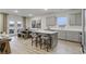 Kitchen and dining area featuring gray cabinets and island seating, open to the outdoor scenery at 945 Laconic Dr., Myrtle Beach, SC 29588