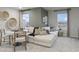 A cozy living room with a large sectional sofa, dining table, and views from the windows at 945 Laconic Dr., Myrtle Beach, SC 29588