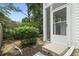 View of the screened-in back porch with steps leading down to mulch filled flower bed at 9550 Dunes Gable Dr. # A, Myrtle Beach, SC 29572