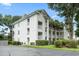 Bright, white, multi-story condo with personal balconies and mature landscaping provides an airy, comfortable atmosphere at 9550 Dunes Gable Dr. # A, Myrtle Beach, SC 29572