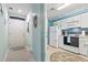 Hallway leading to kitchen featuring white doors, light blue walls, and charming decor at 9550 Dunes Gable Dr. # A, Myrtle Beach, SC 29572
