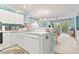Bright kitchen features white cabinets, appliances, and a view into the light-filled living area at 9550 Dunes Gable Dr. # A, Myrtle Beach, SC 29572