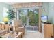 Cozy seating on the screened in porch provides ample sunlight and a tranquil view at 9550 Dunes Gable Dr. # A, Myrtle Beach, SC 29572