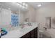 Clean bathroom with vanity, framed mirror, a shower-tub with curtain, and ceramic tiled floors at 101 Alpharetta Ct., Conway, SC 29526