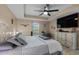 Luxurious primary bedroom with a tray ceiling, ceiling fan, and decorative touches for a relaxing atmosphere at 101 Alpharetta Ct., Conway, SC 29526