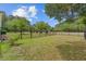 Large, grassy backyard with a black metal fence and mature trees at 101 Fulbourn Pl., Myrtle Beach, SC 29579
