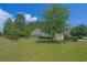 A spacious backyard with a well-maintained lawn and mature trees, perfect for outdoor activities at 101 Fulbourn Pl., Myrtle Beach, SC 29579