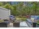 Relaxing backyard patio with outdoor seating and a view of the wooded backyard at 101 Fulbourn Pl., Myrtle Beach, SC 29579