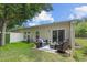 Cozy backyard patio with outdoor seating, sliding door access, and a view of the wooded backyard at 101 Fulbourn Pl., Myrtle Beach, SC 29579