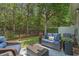 Inviting backyard patio with outdoor seating and a view of the wooded backyard at 101 Fulbourn Pl., Myrtle Beach, SC 29579