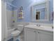 Bright bathroom with a shower-tub combo, blue accents, white vanity, and a framed mirror at 101 Fulbourn Pl., Myrtle Beach, SC 29579