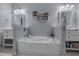 Spacious bathroom features a standalone tub, double vanity, modern finishes and wall decor at 101 Fulbourn Pl., Myrtle Beach, SC 29579