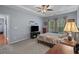 Relaxing bedroom with gray walls, a tray ceiling, and natural light from the windows at 101 Fulbourn Pl., Myrtle Beach, SC 29579