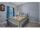 Cozy bedroom with a bed, blue curtains, a window and a vintage clock at 101 Fulbourn Pl., Myrtle Beach, SC 29579