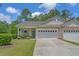 Charming single-Gathering home with a well-manicured lawn, driveway, attached garages, and cozy front porch at 101 Fulbourn Pl., Myrtle Beach, SC 29579