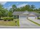 Charming single-story home featuring a two-car garage, well-manicured lawn, and lovely landscaping at 101 Fulbourn Pl., Myrtle Beach, SC 29579