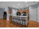 Open kitchen with hardwood floors, island with bar stools and connects to the living areas at 101 Fulbourn Pl., Myrtle Beach, SC 29579
