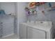 Laundry room with shelving and modern white washer and dryer units at 101 Fulbourn Pl., Myrtle Beach, SC 29579