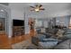 Cozy living room with hardwood floors, sectional sofa, and view to the kitchen and dining area at 101 Fulbourn Pl., Myrtle Beach, SC 29579