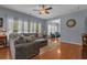 Comfortable living room with large sectional sofa, hardwood floors, and plenty of natural light at 101 Fulbourn Pl., Myrtle Beach, SC 29579