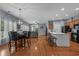Open-concept living space with hardwood floors, a modern island and dining area at 101 Fulbourn Pl., Myrtle Beach, SC 29579