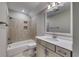Modern bathroom featuring a combined tub and shower, beige tile, a white vanity, and quartz countertop at 1055 Laconic Dr., Myrtle Beach, SC 29588