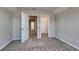 Bright bedroom with neutral walls, carpet, and access to a closet and other parts of the house at 1055 Laconic Dr., Myrtle Beach, SC 29588