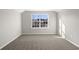 Neutral bedroom featuring a large window, base molding, and carpet at 1055 Laconic Dr., Myrtle Beach, SC 29588